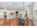 Open-concept living space featuring a kitchen, dining area, and living room with a fireplace at 5210 Valley Stream Rd, Charlotte, NC 28209