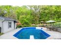 Backyard pool with a diving board, patio furniture, and fenced in for privacy at 5486 Suttlemyre Ln, Hickory, NC 28601