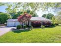 Inviting home featuring a well-maintained lawn, mature trees, and attached two-car garage, offering suburban charm at 695 Linwood Rd, Mooresville, NC 28115