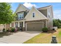 Beautiful two-story home with stone accents, a two-car garage, and a well-manicured front yard at 7039 Chrysanthemum Rd, Lancaster, SC 29720