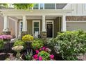 Inviting covered front porch with rocking chairs, flower boxes, and a lovely wreath on the front door at 7039 Chrysanthemum Rd, Lancaster, SC 29720