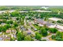 Aerial view of the property, its location in the neighborhood, and nearby commercial and industrial area at 704 E Catawba St, Belmont, NC 28012