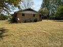 The backyard features an AC unit, brick facade, and chain-link fence at 785 Nc Highway 109 N Hwy, Troy, NC 27371