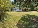 Charming ranch-style home featuring a spacious yard, front porch, and mature trees at 785 Nc Highway 109 N Hwy, Troy, NC 27371