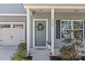 Welcoming front porch features gray siding, a charming wreath, and well-maintained landscaping, enhancing curb appeal at 1062 River Haven Sw Ave, Concord, NC 28025