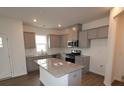 Well-lit kitchen features gray cabinetry, granite countertops, stainless steel appliances, and a central island at 1119 Overbrook Pl, Wingate, NC 28174