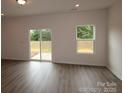 Bright living room with wood floors, natural light from windows and sliding glass doors to outdoor space at 1119 Overbrook Pl, Wingate, NC 28174