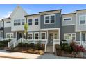 Charming two-story townhouse with blue and white siding, landscaped front yard, and inviting entryway at 131 Berkeley Ave # D, Mooresville, NC 28117