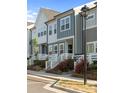 Attractive townhomes with manicured lawns and vibrant red roses lining walkway at 131 Berkeley Ave # D, Mooresville, NC 28117