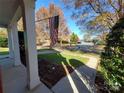 American flag displayed from the front porch of a well-maintained home, showcasing neighborhood views at 1508 Peaceful Way Dr, Charlotte, NC 28206