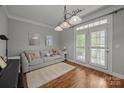 Bright living room featuring a comfortable sofa and French doors at 1508 Peaceful Way Dr, Charlotte, NC 28206