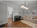 Cozy living room with plush sofa, piano, and stylish chandelier at 1508 Peaceful Way Dr, Charlotte, NC 28206