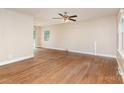 Spacious living room with hardwood floors, ceiling fan, and ample natural light from windows at 1532 Downs Ave, Charlotte, NC 28205