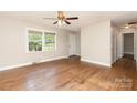 Bright living room featuring hardwood floors, ceiling fan, and front door at 1532 Downs Ave, Charlotte, NC 28205