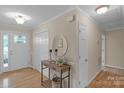 Warm foyer with hardwood floors, a console table, and a decorative mirror offering a welcoming entry at 1607 Old Lawyers Rd, Marshville, NC 28103