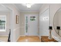 Inviting foyer featuring hardwood floors, neutral walls, and a front door with decorative glass inserts at 1607 Old Lawyers Rd, Marshville, NC 28103