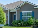 Charming home featuring well-maintained landscaping and bright blue shutters at 170 Atwater Landing Dr, Mooresville, NC 28117