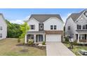 Inviting two-story home with a stone facade, a cozy porch, and a well-manicured front yard at 190 Tetcott St, Mooresville, NC 28115