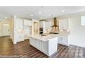 Spacious kitchen with white cabinets, stainless steel appliances, and a large center island at 2012 Embassy Ct # 46, Charlotte, NC 28213