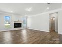 Spacious living room featuring a fireplace, hardwood floors, and plenty of natural light at 2012 Embassy Ct # 46, Charlotte, NC 28213