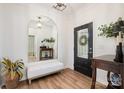 Bright entryway featuring wood floors, an arched mirror, bench, and stylish decor at 2158 Winhall Rd, Fort Mill, SC 29715
