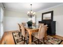 Cozy dining room features natural light, decorative rug, and black cabinet accenting the space at 2382 Erika Ln, Gastonia, NC 28056