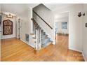 Inviting entryway features hardwood floors, staircase and white trim that leads to the living areas at 2382 Erika Ln, Gastonia, NC 28056