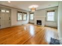 Inviting living room featuring a fireplace, hardwood flooring, and natural light at 2400 Commonwealth Ave, Charlotte, NC 28205