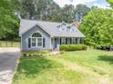 Inviting gray home with neat landscaping and traditional architectural details and trimmed shrubbery at 2439 Caswell Ct, Gastonia, NC 28054