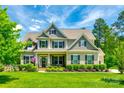 Charming two-story home with a well-manicured lawn, inviting front porch, and beautiful curb appeal at 288 Ridge Reserve Dr, Lake Wylie, SC 29710