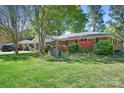 A charming single-story brick home with well-maintained landscaping, including lush green lawns and colorful shrubbery at 3265 W Innes St, Salisbury, NC 28144