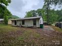A view of the back exterior with a modest yard at 4406 Valeview Ln, Charlotte, NC 28269