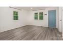 Bright living room with modern floors and an inviting blue door at 500 3Rd St, Stanley, NC 28164