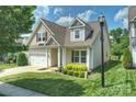 Attractive single-Gathering home with a lush green lawn, covered porch, and attached two-car garage at 505 Chamberlain Ct, McAdenville, NC 28101