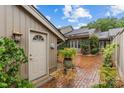 Inviting side entrance to a charming home with a brick walkway and well-maintained landscaping at 5306 Sandtrap Ln, Charlotte, NC 28226