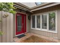 Elegant front door with glass detailing, complemented by brick walkway and manicured landscaping at 5306 Sandtrap Ln, Charlotte, NC 28226