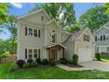 View of the home featuring a covered front entry and a two-car attached garage with a basketball hoop at 6101 Park Hill Rd, Charlotte, NC 28277