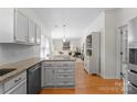 Open concept kitchen featuring stainless steel appliances, granite counters and seamless transition to living area at 6101 Park Hill Rd, Charlotte, NC 28277