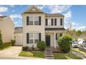 Charming two-story home features manicured lawn, black shutters, and neutral siding on a corner lot at 8424 Spirea Ct, Charlotte, NC 28215