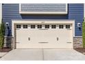 Close-up view of the garage door showcasing carriage-house design and address numbers at 8429 Golden Stone Ln, Fort Mill, SC 29707