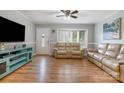 Inviting living room with stylish sofas, a ceiling fan, and a bright window view at 907 E 9Th Ave, Gastonia, NC 28054
