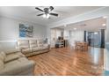 Open-concept living area with dining space, light gray walls, and durable laminate flooring at 907 E 9Th Ave, Gastonia, NC 28054