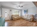Comfortable living room featuring two leather sofas and a ceiling fan for a cozy space at 907 E 9Th Ave, Gastonia, NC 28054