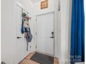 Inviting entryway with coat rack, wood floors, and white door at 1009 Rainbow Cir, Catawba, SC 29704