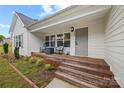 Inviting front porch with rocking chairs, wood deck and covered entry at 1009 Rainbow Cir, Catawba, SC 29704