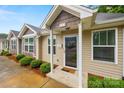 Inviting home exterior with detailed trim, a covered entry, and neat landscaping at 117 S Canyon Ridge S Dr, Mount Holly, NC 28120