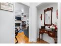 Inviting entryway with wood floors, decorative mirror, and a glimpse into the cozy living room at 1287 Queensgate St, Gastonia, NC 28054