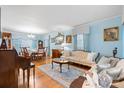 Spacious living room with a piano and dining room featuring hardwood floors and ample natural light at 1287 Queensgate St, Gastonia, NC 28054