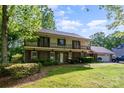 Attractive home with well-maintained lawn, mature trees, and attached two-car garage at 1340 Piccadilly Dr, Charlotte, NC 28211