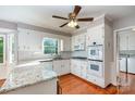 Bright kitchen featuring white cabinets, granite countertops, and stainless steel appliances at 1340 Piccadilly Dr, Charlotte, NC 28211